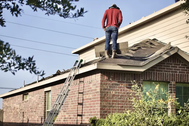 Professional roofer working on a residential roof in Ravenna
